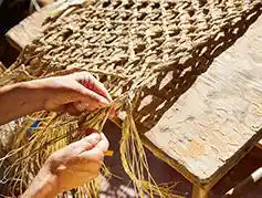 Artisan weaving a basket